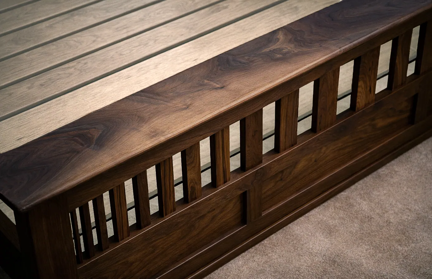Detail of walnut bed footboard showing varied slat widths and figure.
