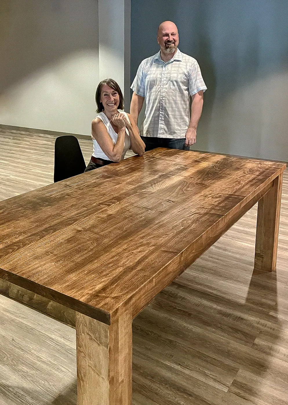 Maple table shown with two people to indicate scale.