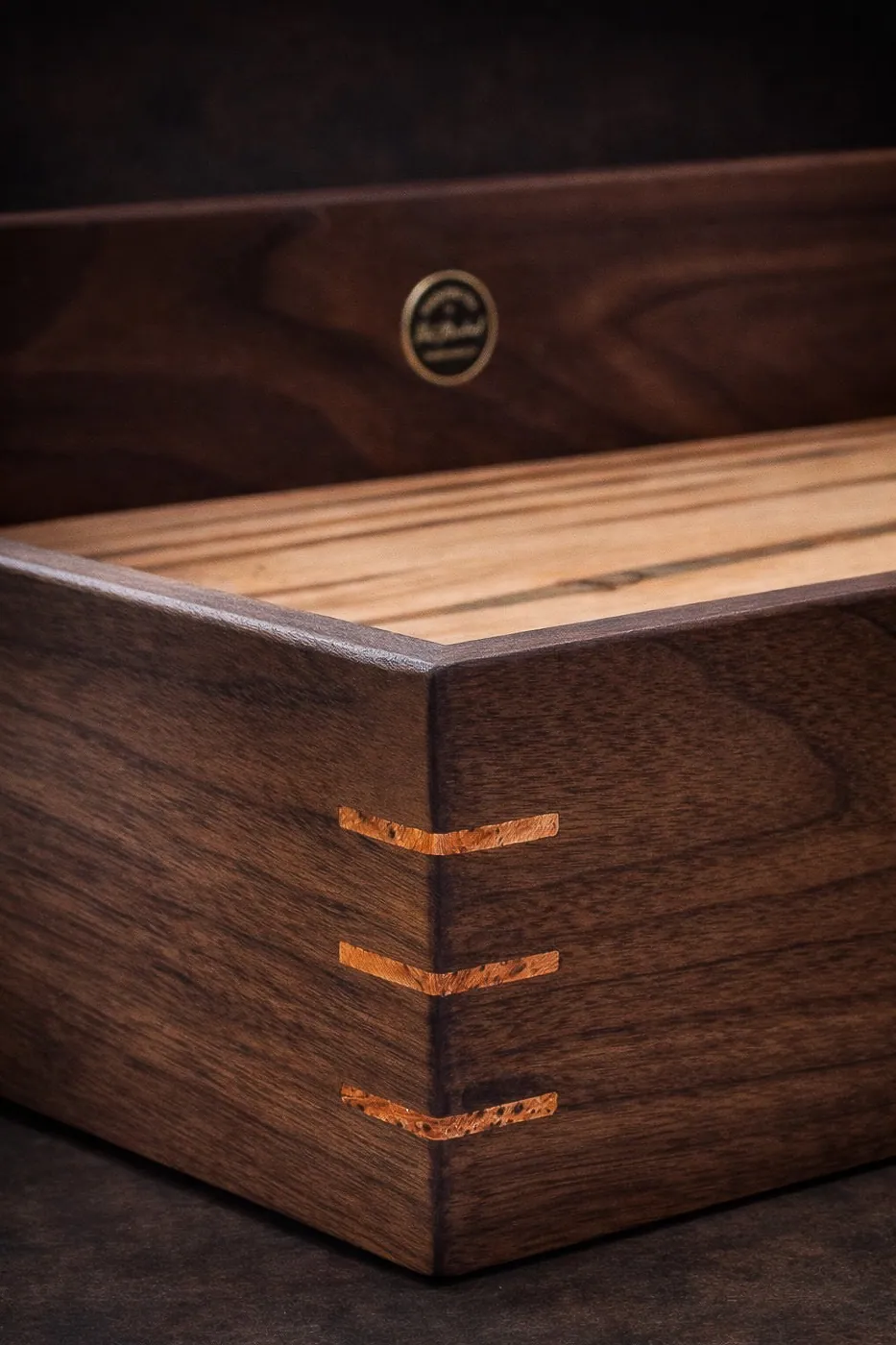 Corner detail of walnut frame with burl spline joinery.